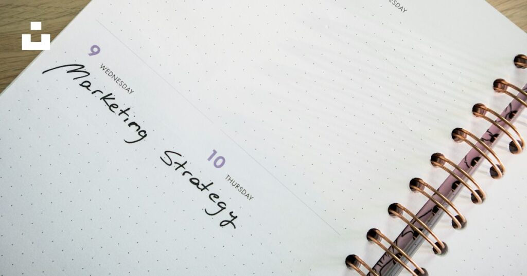 A paper planner with a pen on top, ready to schedule appointments