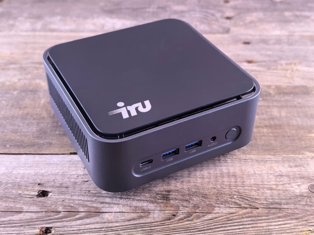 Sleek mini PC computer on a wooden desk